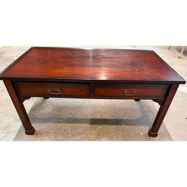 Vintage Chippendale high quality dark wood coffee table with a rich red-brown finish, two front drawers featuring...