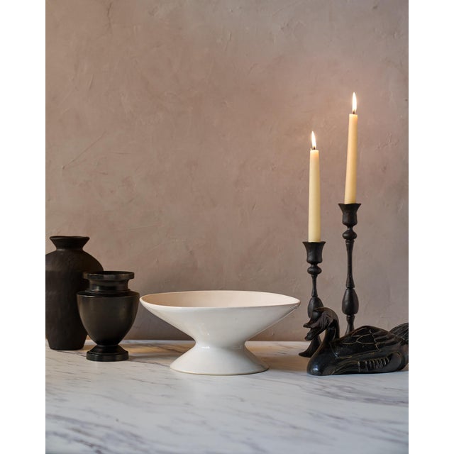 The Medium Handcrafted Ceramic Pedestal Bowl by NPage Studio X Lostine is a sculptural decorative vessel that blends...