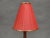 Authentic danish mid century table lamp from the 1960s, crafted from solid teak wood and fitted with a red pleated shade...