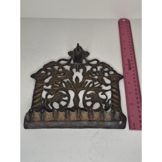 This is an exceptional example of a traditional Eastern European "bench-type" Hanukkah lamp. The backplate is an intricate...