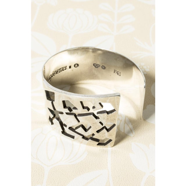 Striking silver bracelet by Claës Giertta, in thick silver quality. Cut-out graphic pattern that looks great against the...