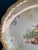 This antique decorative plate by D.E. McNicol features a softly scalloped edge, creamy ivory glaze, and a finely detailed...