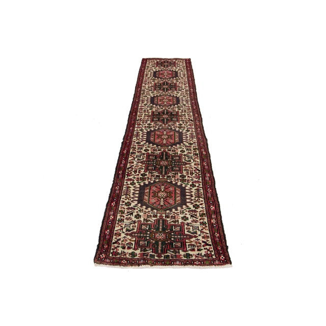 Elevate your space with this exquisite Vintage Heriz Handmade Wool Rug, featuring a timeless beige field accentuated by...