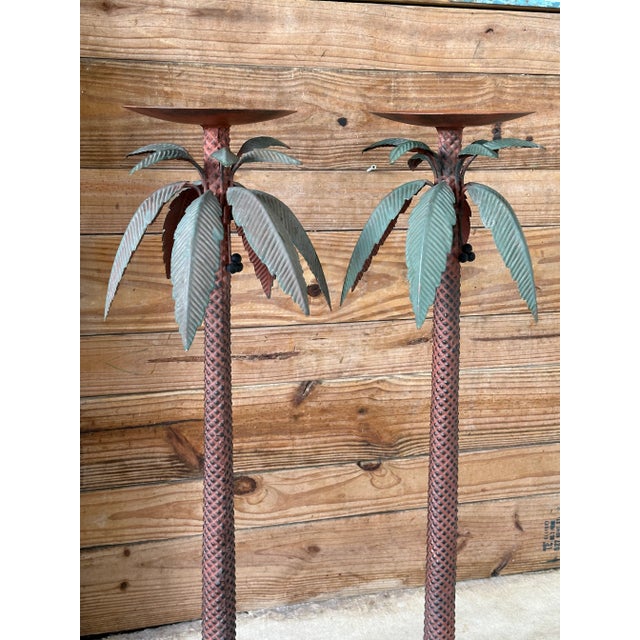 A whimsical pair of vintage metal floor candle holders designed as tall, sculptural palm trees. Each features a...