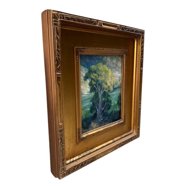 A luminous original landscape painting centered on a single sunlit tree set within a soft, atmospheric field. Executed...