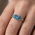 Dive into a world of serene, captivating brilliance with this exquisite 18k gold-plated two-stone ring. Featuring a pair...