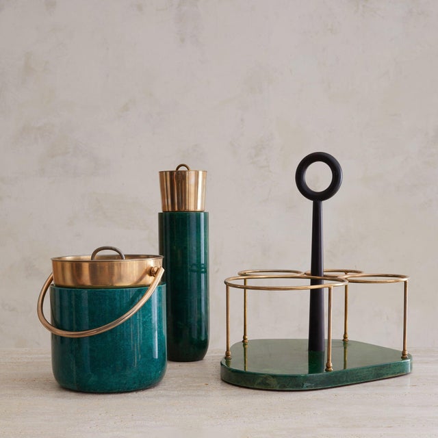 A 1970s Italian cocktail set attributed to Aldo Tura, composed of a coordinating ice bucket, cocktail shaker, and carrier....