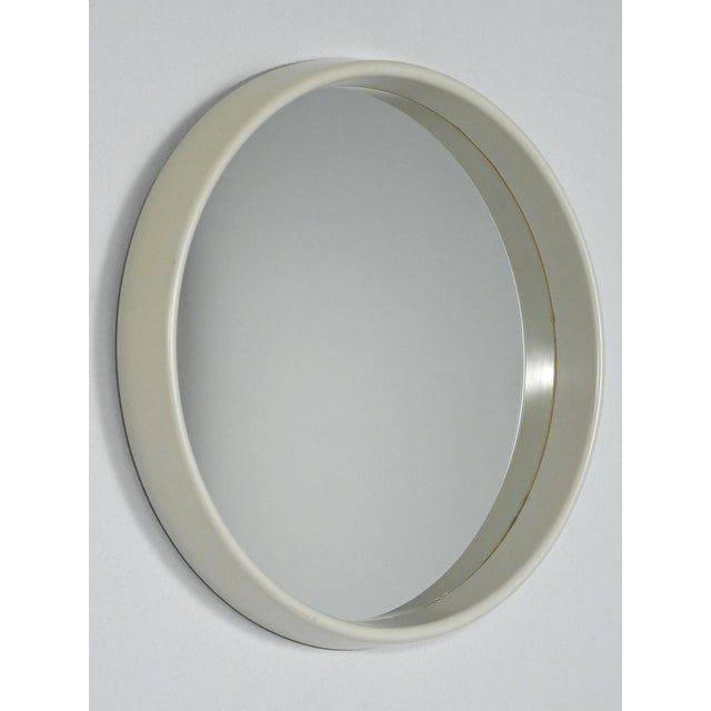 Round mirror from the 1960s with a cream-white rigid plastic frame, a protruding edge, and clean lines. A cream-white...