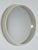 Round mirror from the 1960s with a cream-white rigid plastic frame, a protruding edge, and clean lines. A cream-white...
