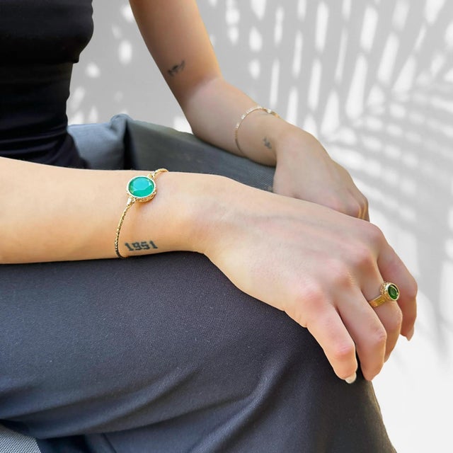 Cleopatra Gold & Green Jade Stone Adjustable Ring is a regal and captivating piece that effortlessly blends ancient allure...