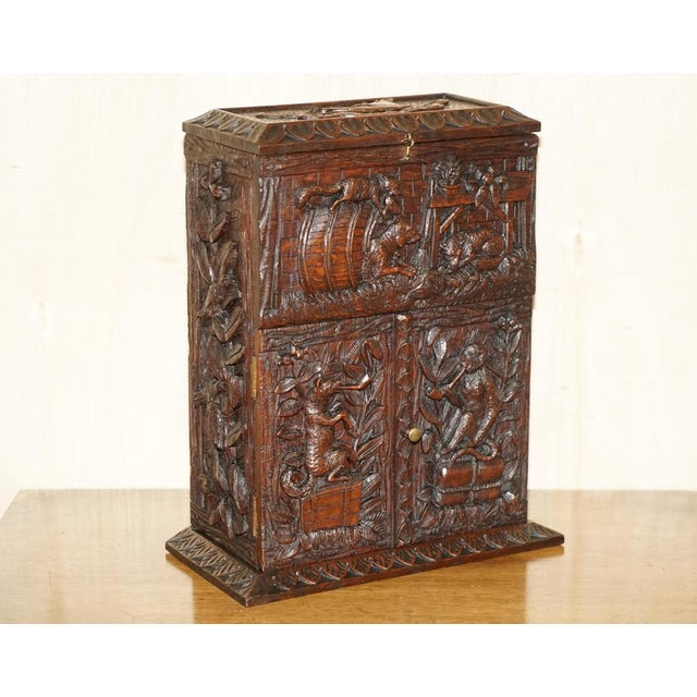 Royal House Antiques is delighted to offer for sale this stunning, hand carved Black Forest wood, smoking pipe cabinet or...
