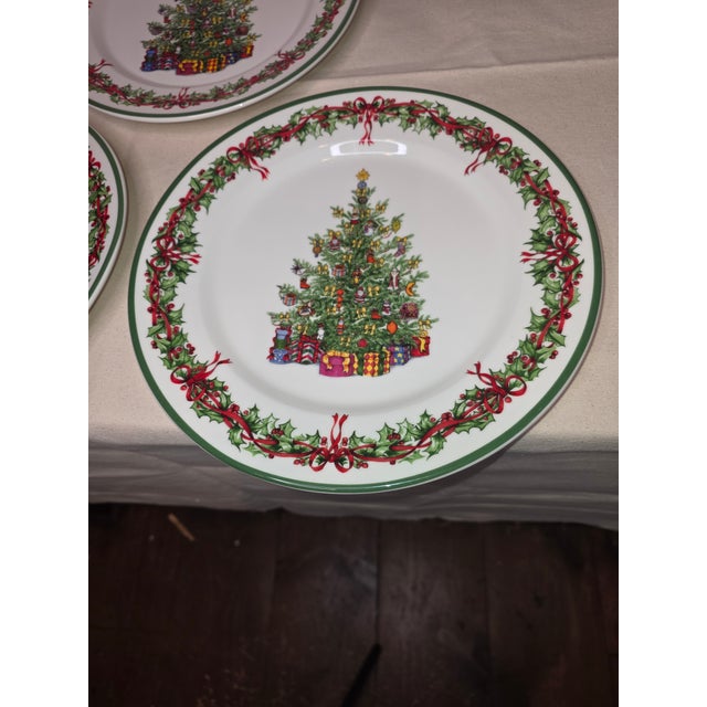 Three Radko Christmas tree dinner plates.