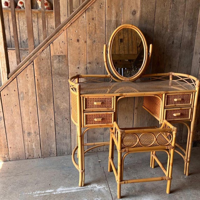 Cane and bamboo dressing table with 4 drawers with bamboo handles. The item has a curved detail all around the top. The...