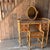Cane and bamboo dressing table with 4 drawers with bamboo handles. The item has a curved detail all around the top. The...