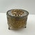 Add a touch of vintage elegance to your vanity or dresser with this beautifully detailed gold tone filigree jewelry box....