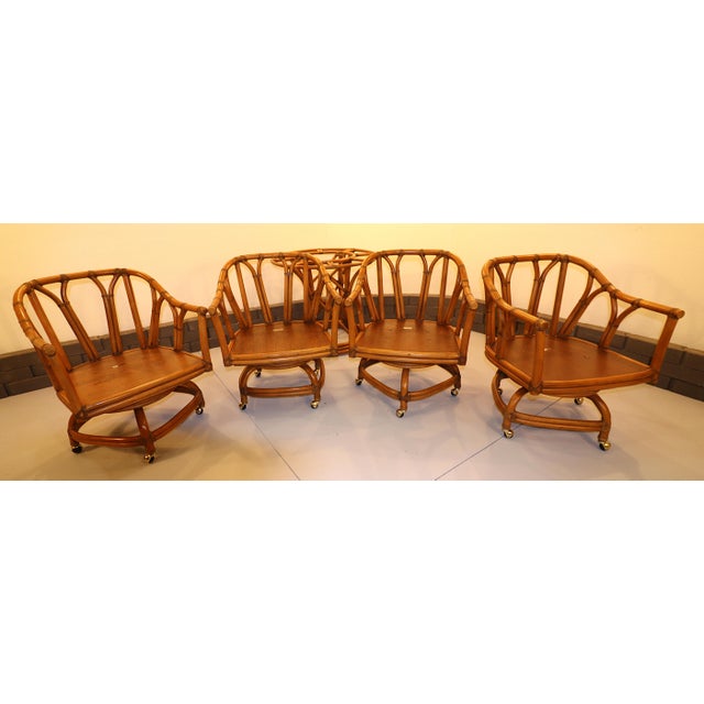 Vintage Ficks Reed Mid-Century Rattan Swivel Rocker Dining Set with Brass Rolling Castors, Rattan Table Base and glass...