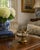 An unusually decorative circa-1940s ashtray combining warm gilded brass with a cool chrome bowl. Cast floral swags,...