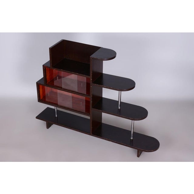 The Art Deco étagère from the 1930s was made in Czechoslovakia. Its construction consists of solid wood with oak veneer,...
