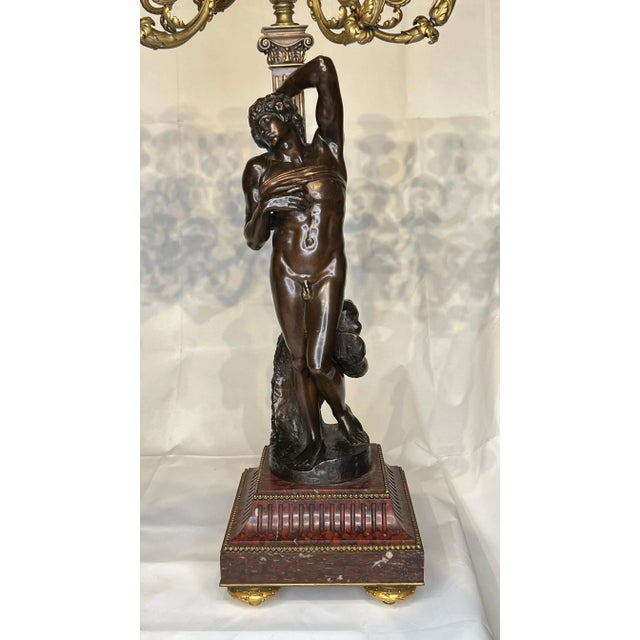 Pair of French 19th century patinated bronze candelabra of the finest quality by Barbedienne of Paris, mounted on rouge...