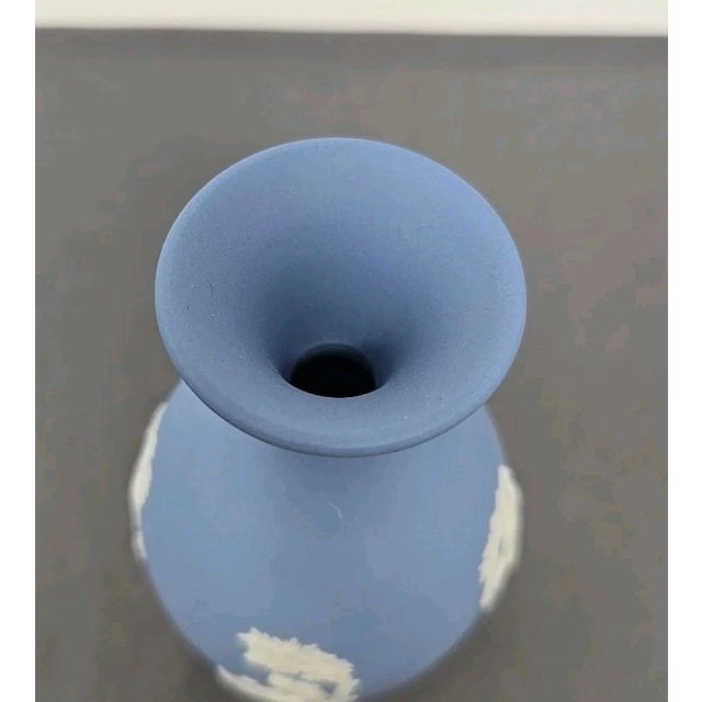 Beautiful pair of vintage bud vases made by Wedgwood, featuring the iconic blue Jasperware with elegant white neoclassical...