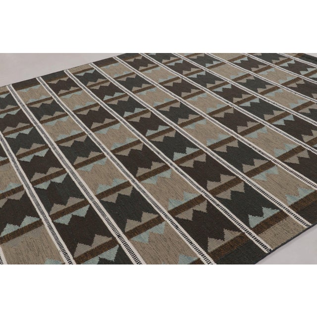 Handwoven in a blend of wool and undyed, natural yarns, this 9x12 flatweave is a premier selection from our contemporary...