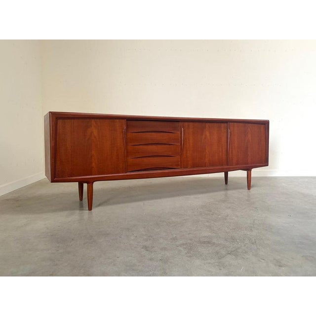 Sideboard designed by Axel Christensen for Aco Møbler, Denmark 1960s. Teak veneer with three slide doors and four drawers....