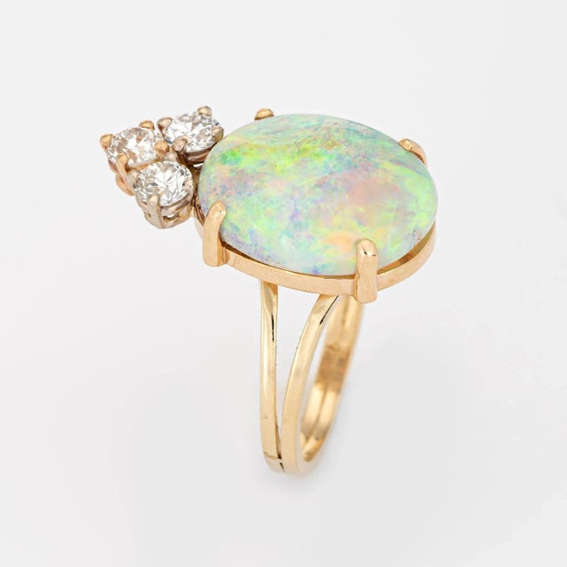 Stylish vintage opal & diamond cocktail ring crafted in 14 karat yellow gold. The natural opal measures 15mm x 11mm...