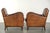 This rugged yet comfortable set of 2 vintage sheepskin armchairs has a great industrial look. The armchairs feature loose...