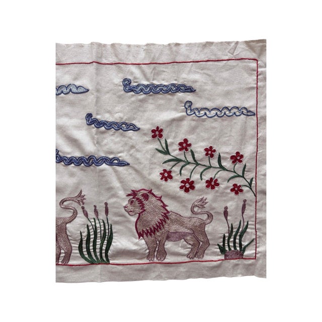 Hand-embroidered Suzani panel from Uzbekistan, worked in fine floss on a cream cotton ground. Three lions move across the...
