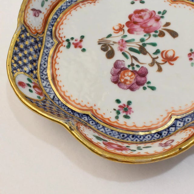 A very fine small Chinese export porcelain bowl. With famille rose decoration, blue underglaze cells, and a scalloped...