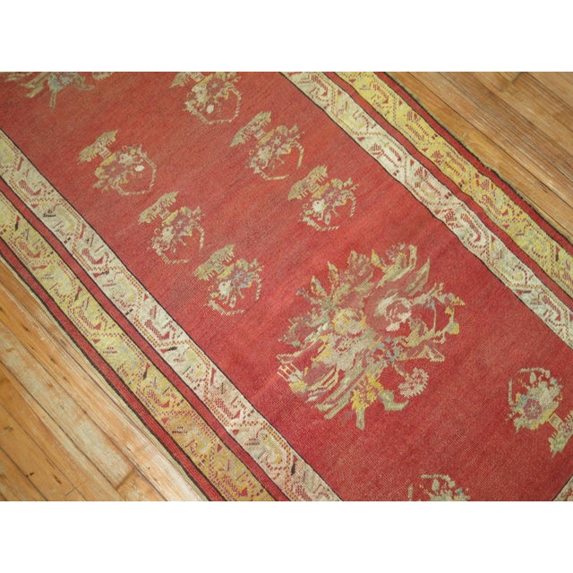 An extravagantly chivalrous late 19th century Turkish runner in Predominant shades of watermelon, yellow and green.