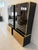 Set of two display cabinets attributed to Renato Zevi, 1970, in brass, gold-plated mirrored glass, and smoked glass. Each...