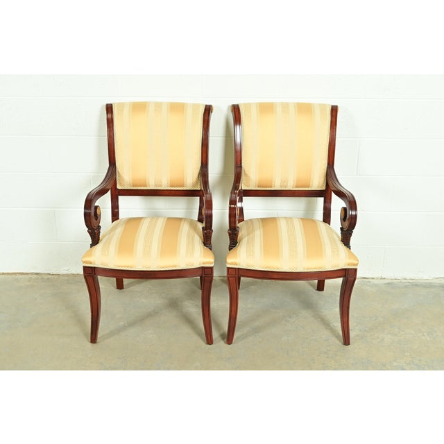 A gorgeous pair of Regency style armchairs or dining captain chairs In the manner of Baker Furniture USA, Circa 1980s...