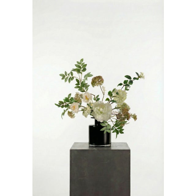 A soft, garden-inspired composition of cream peony, white tulips, and delicate Queen Anne’s lace. Fresh greenery adds...
