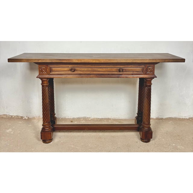 Elegant Spanish console table crafted in walnut featuring a single long drawer and beautifully turned barley twist legs....
