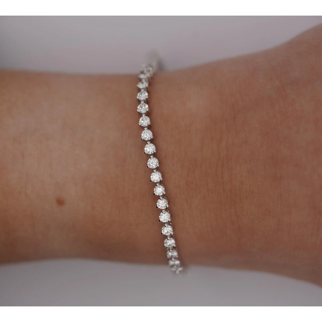 Natural Diamond Unisex Tennis Bracelet in White Gold. A modern piece, this diamond bracelet features 54 round-cut white...