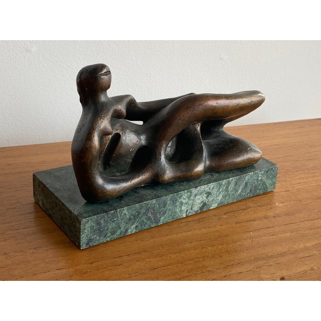(British, 1898-1986). Patinated gold leaf over plaster sculpture with marble base of a Henry Moore reclining figure from...