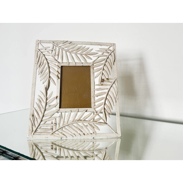 Pair of vintage metal picture frames featuring an intricate leaf motif in the Hollywood Regency style. Their versatile...