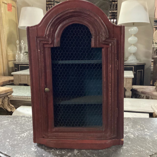 An Italian petite curio cabinet from the early 19th century. This early 19th C Italian curio cabinet has a marvelous moody...