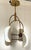 Original retail $3380, stylish Arteriors Modern Brass and Opal Glass Roll Chandelier, showroom floor sample