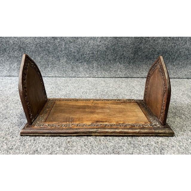 This early 1900s mahogany adjustable bookend set features intricately carved Gothic-style panels with winged griffins and...