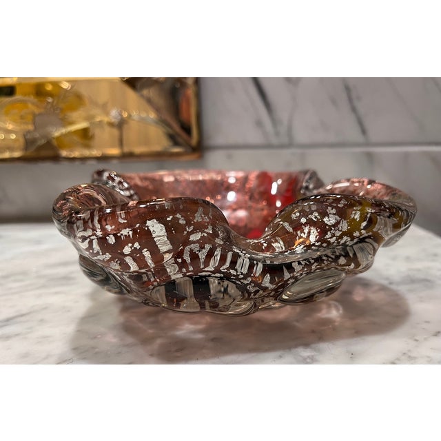 Beautiful Murano style catchall with lots of motion in the glass. Silver patterning on the underside and color streaks and...