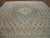 Ivory field, ivory border, generally very light tonality without being pastel make this squarish antique Oushak carpet...
