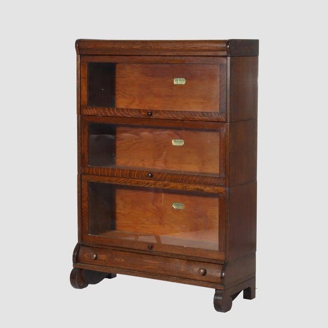 An authentic Lundstrom Arts & Crafts oak 3-stack barrister bookcase, dating to circa 1920. Crafted from solid quarter-sawn...