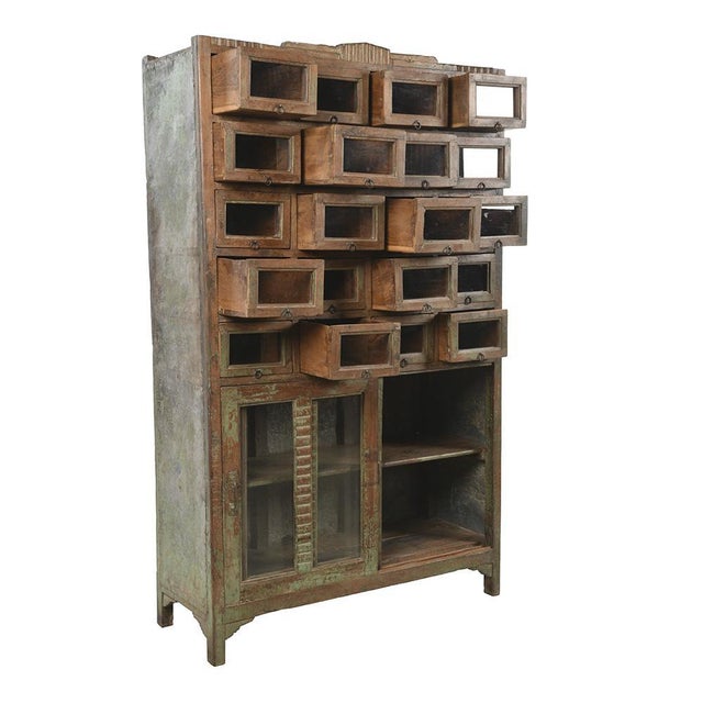 Old wooden presentation furniture with 20 glass compartments & sliding doors. This piece is designed in the style of the...
