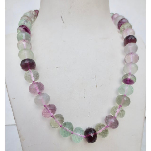 Faceted beads of fluorite show the deep purple strands to light pink and green colors of the stone. Silver 925 toggle...