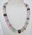 Faceted beads of fluorite show the deep purple strands to light pink and green colors of the stone. Silver 925 toggle...