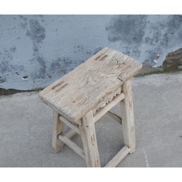 A charming vintage Chinese stool crafted from solid elmwood, dating to the first half of the 20th century. The thick,...