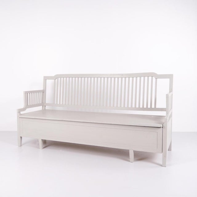 Antique storage bench from the 1860s in grey-painted pine wood with high back and storage. Antique storage bench from the...