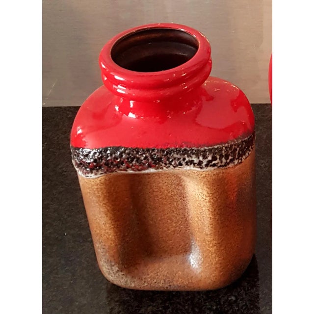 The vase on the left is produced by the manufacturer Steuler. This piece has an attribution mark, I am sure that it is...